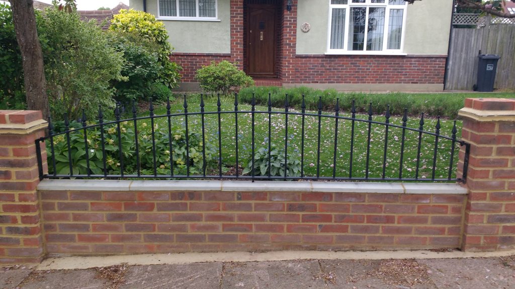 Metal garden wall railing with curved top
